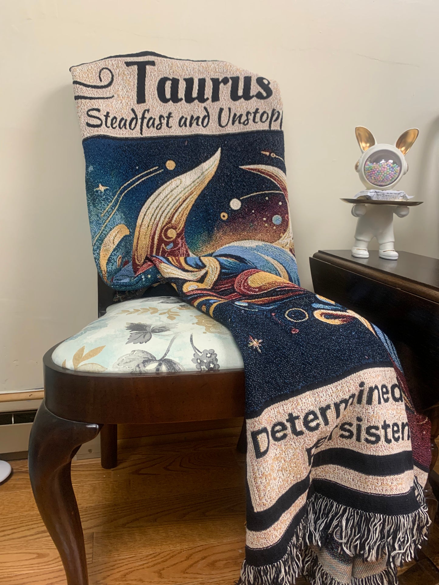 Taurus Heirloom Blanket Mister Obtuse Mugs and Stuff draped over sitting chair with bunny on side table