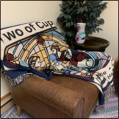 Two of Cups Heirloom Blanket Mister Obtuse Eclectic Goods draped over brown leather chair