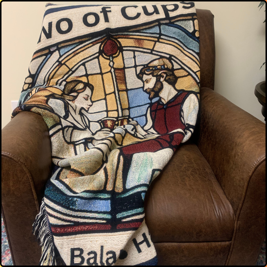 Two of Cups Heirloom Blanket Mister Obtuse Eclectic Goods draped over brown leather chair front view